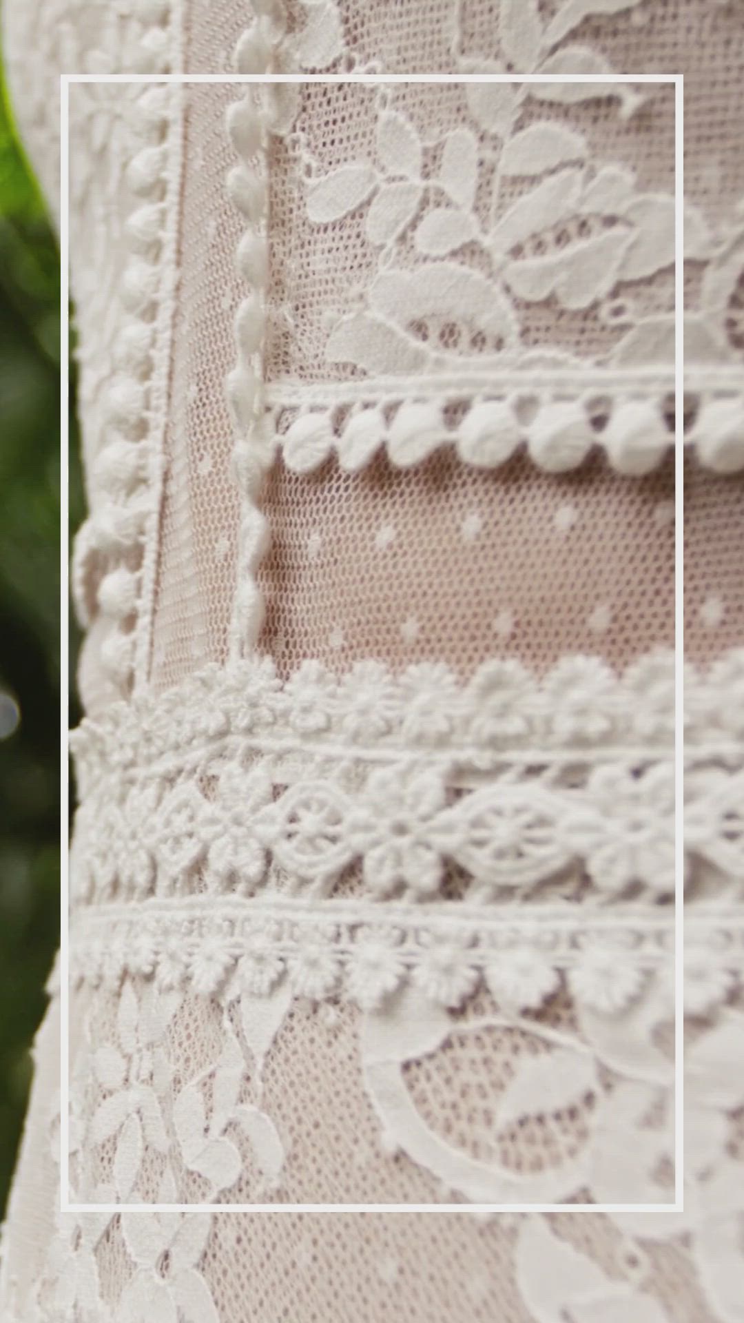 This may contain: a woman in a wedding dress with long sleeves and tiered skirt is posing for the camera