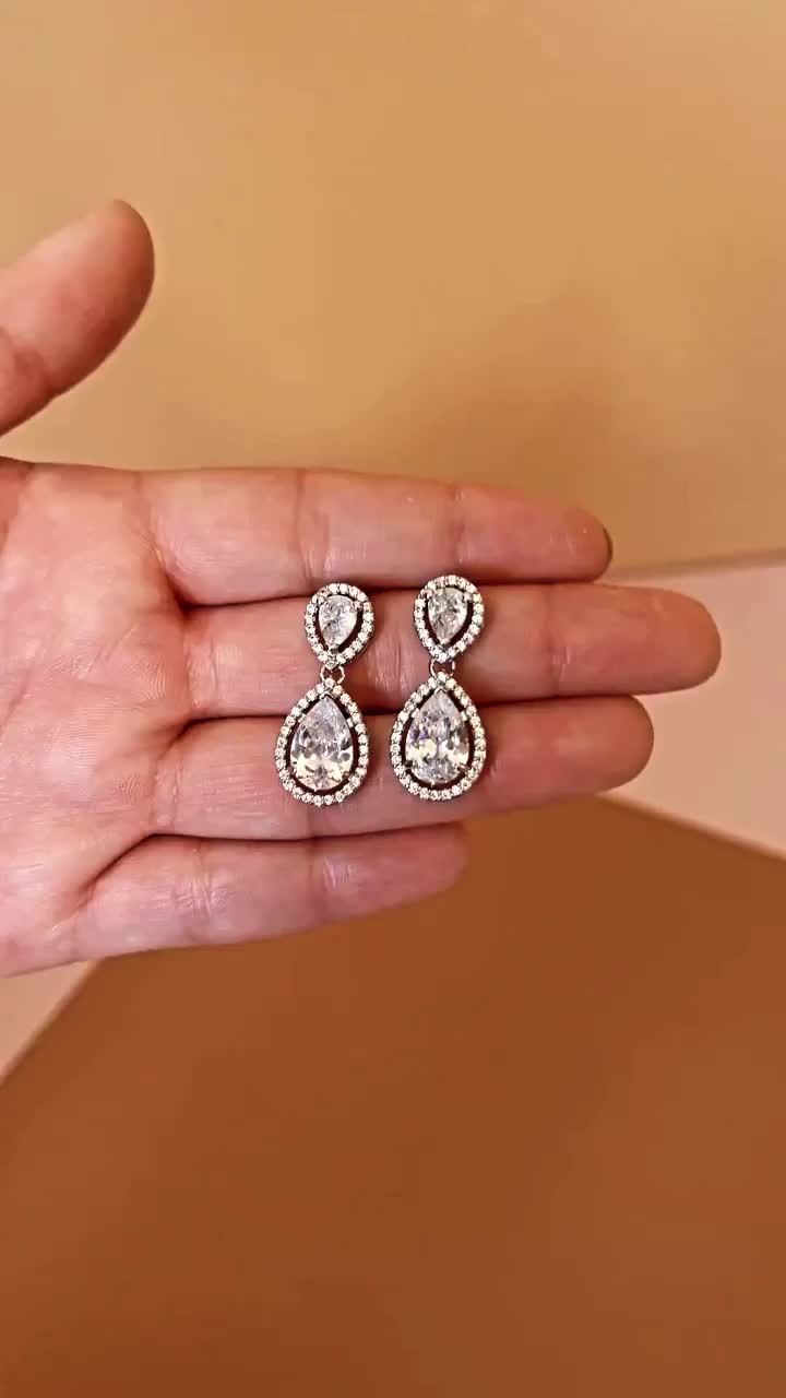 Our Gorgeous HOPE Simulated Diamond Drop Earrings with tear drop shaped diamonds. The HOPE Earrings can be styled with most of our wedding headpieces, Bridal Tiaras and Crowns. These are perfect for adding a delicate touch of sparkle. Handcrafted with Highest Quality CZ Crystals Platinum plated Guards against scratches and tarnish. Approx. Length 1" Approx. Width 0.5" Nickel free Complete This Look: AURORA Swarovski Regular Crown