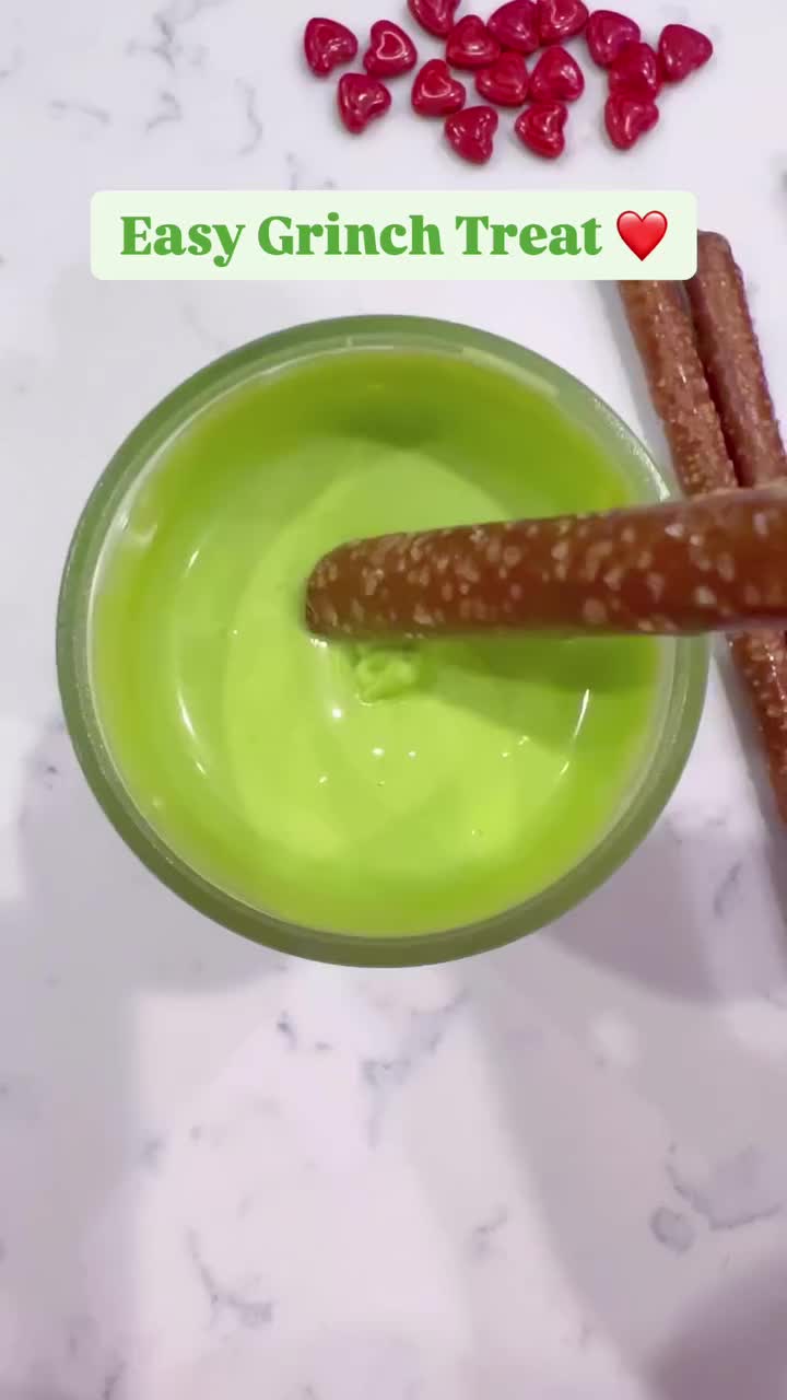 This contains: The Grinch Green Pretzel Sticks with red heart candy