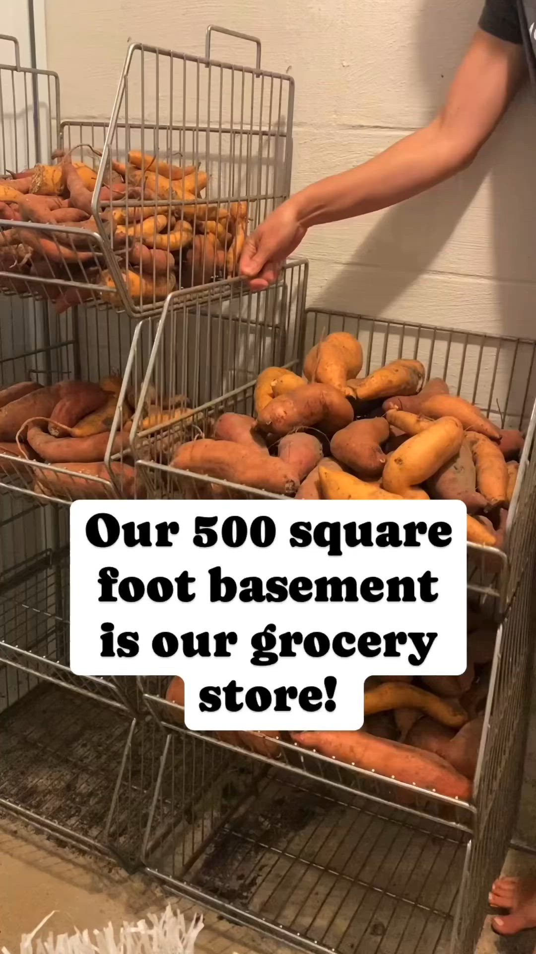 This may contain: there is a man standing next to some baskets with doughnuts in it and the caption reads, our 50 square foot basement is our grocery store