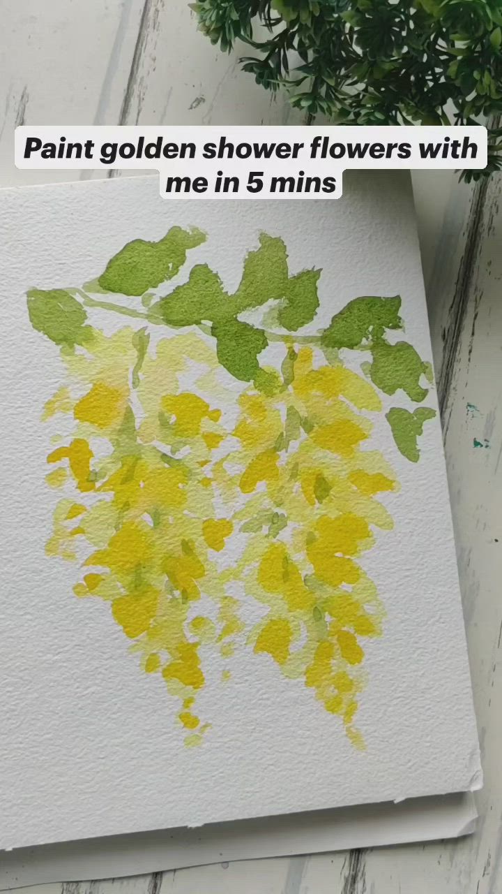 This may contain: a plant with yellow flowers painted on it next to a piece of paper that says paint golden flowers with me in 6 mins