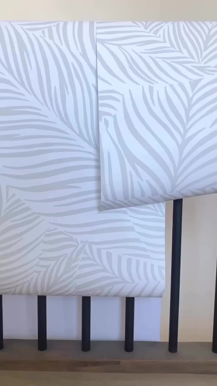 This may contain: a pair of black and white zebra print headboards on a wooden shelf next to a wall