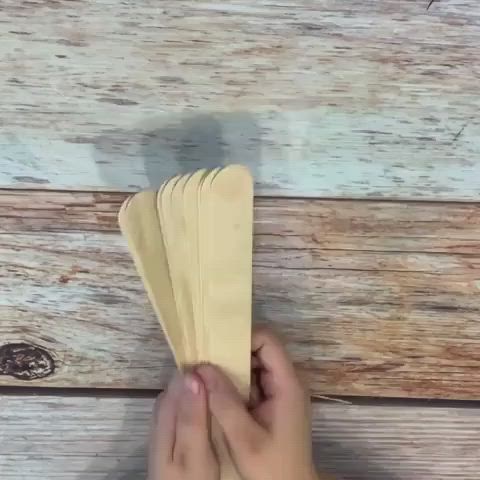 This may contain: a hand holding a piece of paper with the words 5 cute popsicle sticks crafts for your home decor