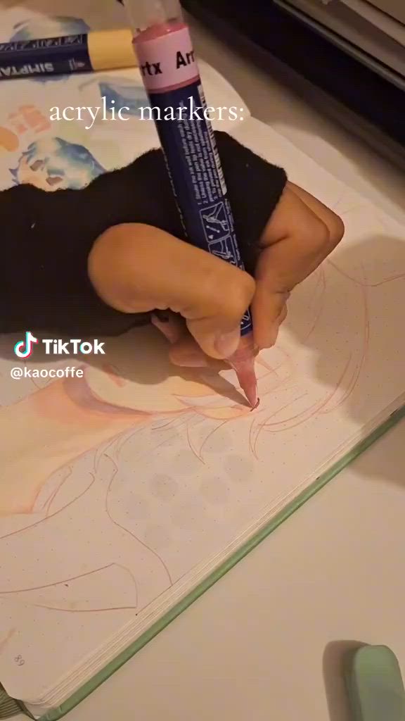 This may contain: a woman is drawing on the floor with markers