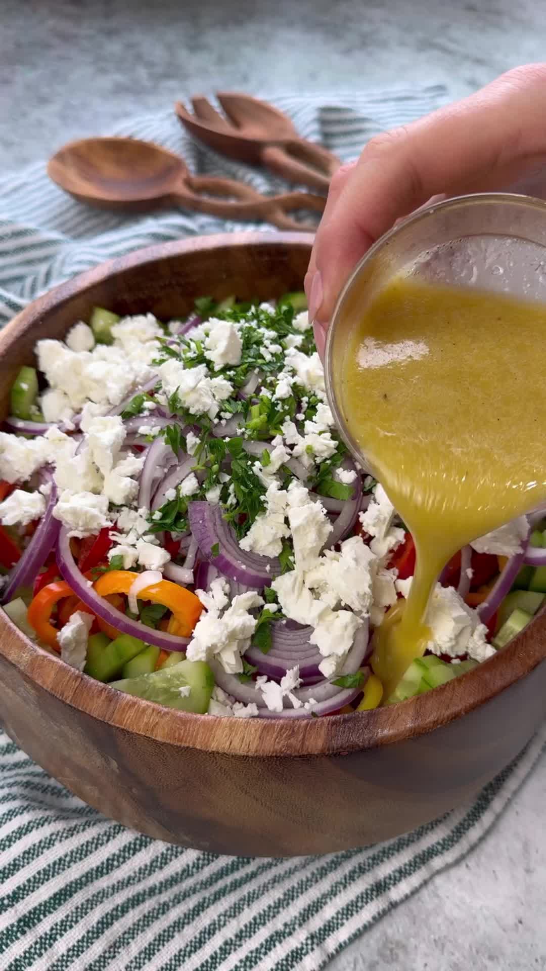 This may contain: a wooden bowl filled with lots of veggies