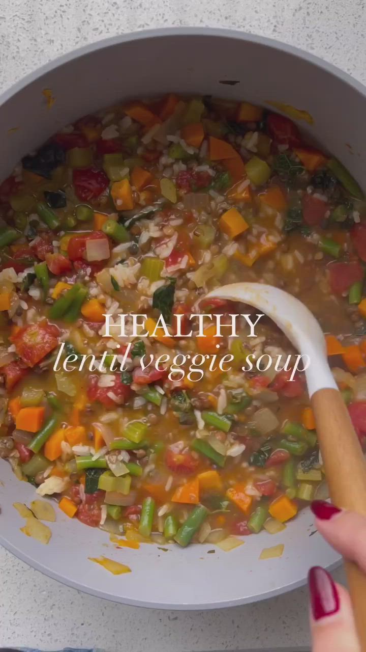 This may contain: a person holding a wooden spoon in a bowl filled with vegetables and soup that says healthy