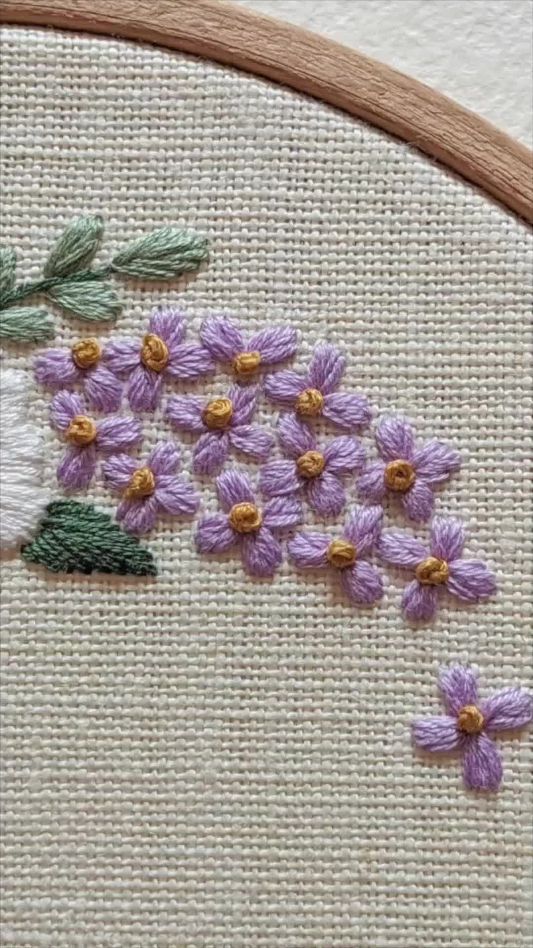 This may contain: a close up of a cross stitch pattern with flowers on it