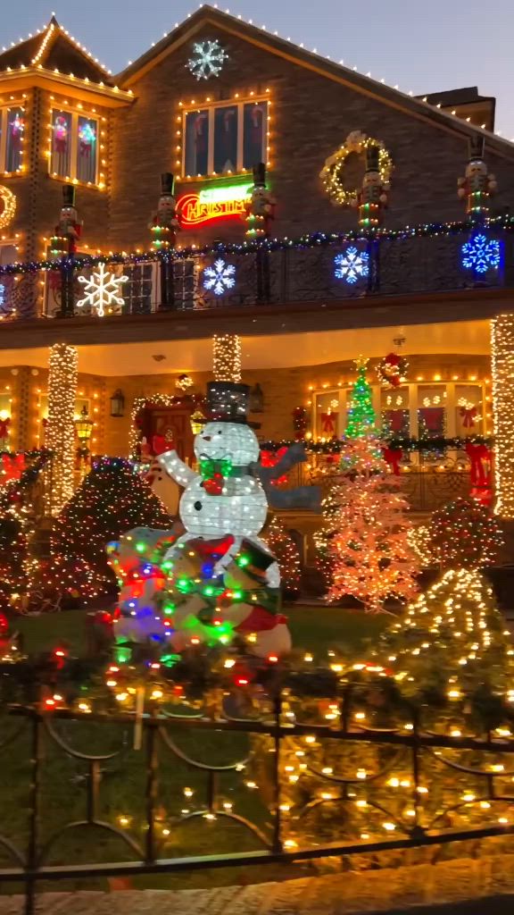 This may contain: a house covered in christmas lights and decorations