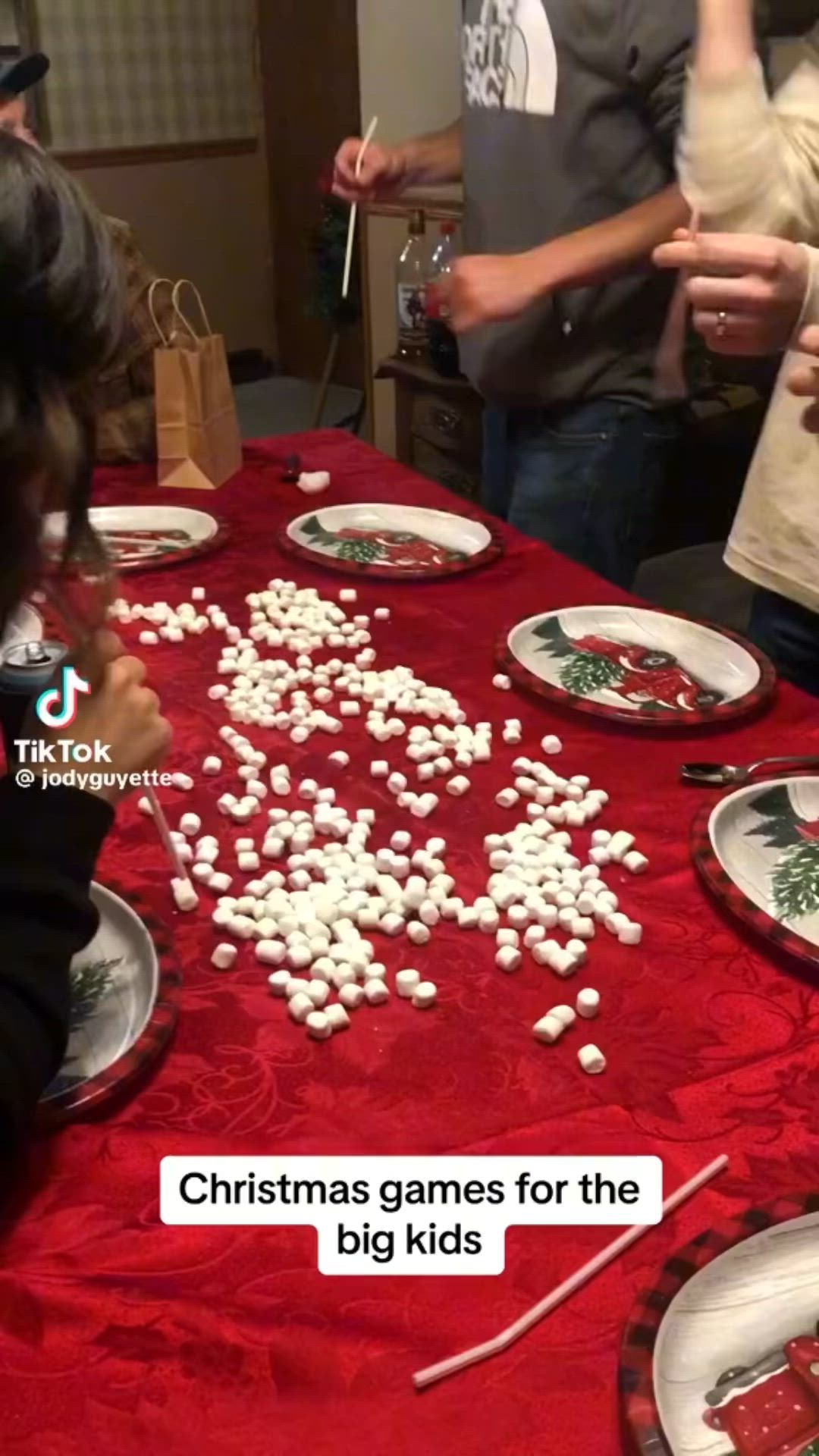 This may contain: children are gathered around a table with christmas games for the big kid's dinner