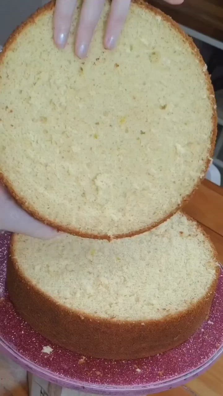 This may contain: a person reaching for a piece of cake on top of a purple plate with pink glitter