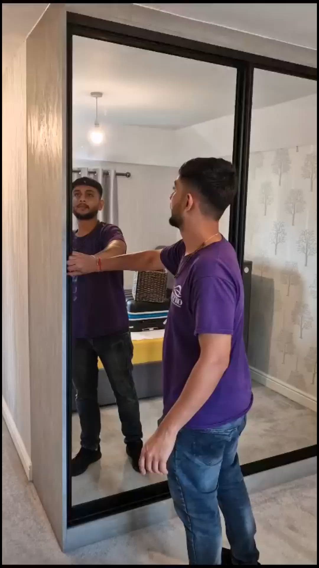 This may contain: two men are standing in front of a mirror