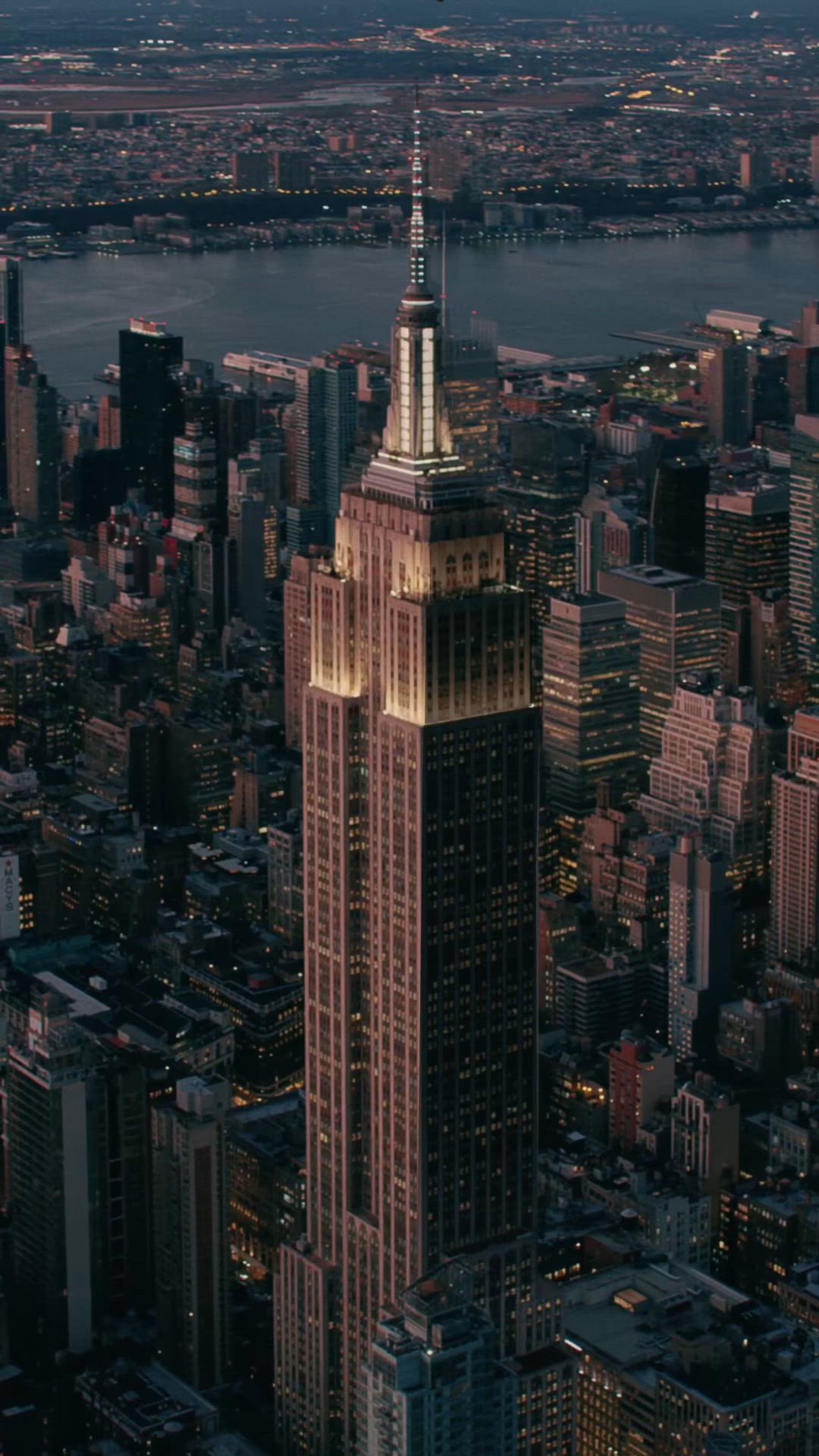 This may contain: an aerial view of the empire building in new york city, with lights on it