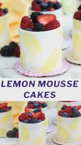 This may contain: lemon mousse cake with berries on top