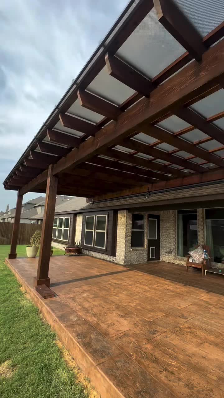 This may contain: a patio covered in wood and glass with an awning over the door to it