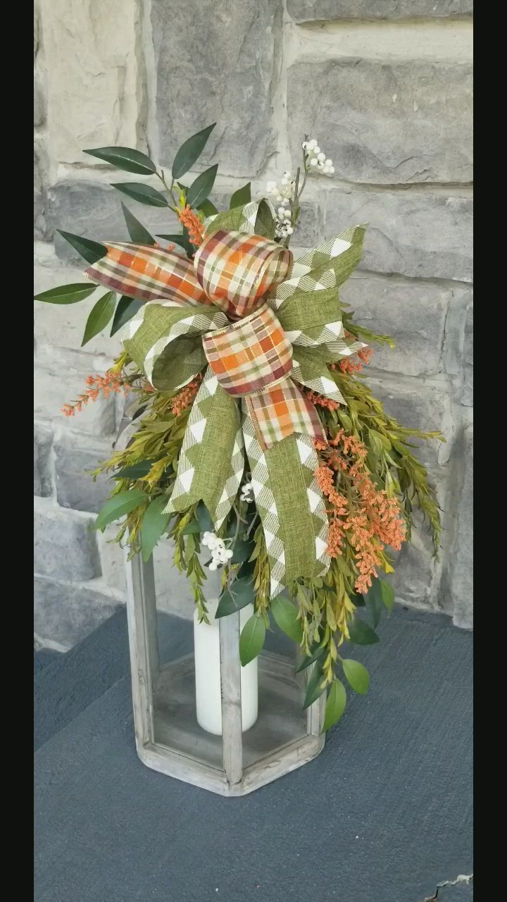 This may contain: a white vase filled with green and orange flowers