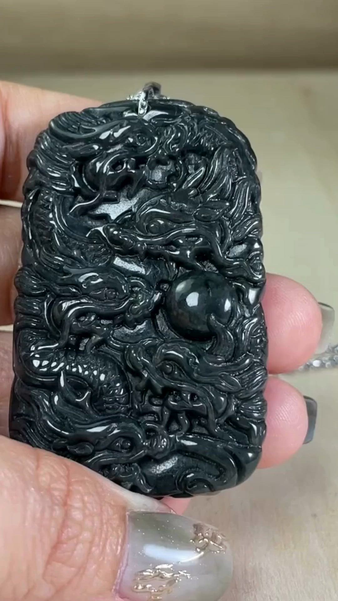 This contains: Black Jade Dragon Necklace