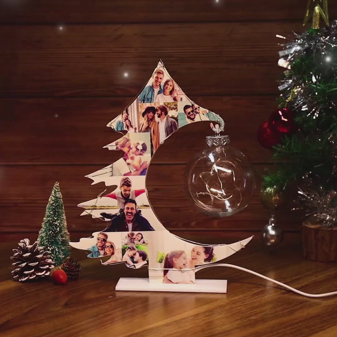 This may contain: a wooden christmas tree with photos on it and a glass ornament in the shape of a crescent