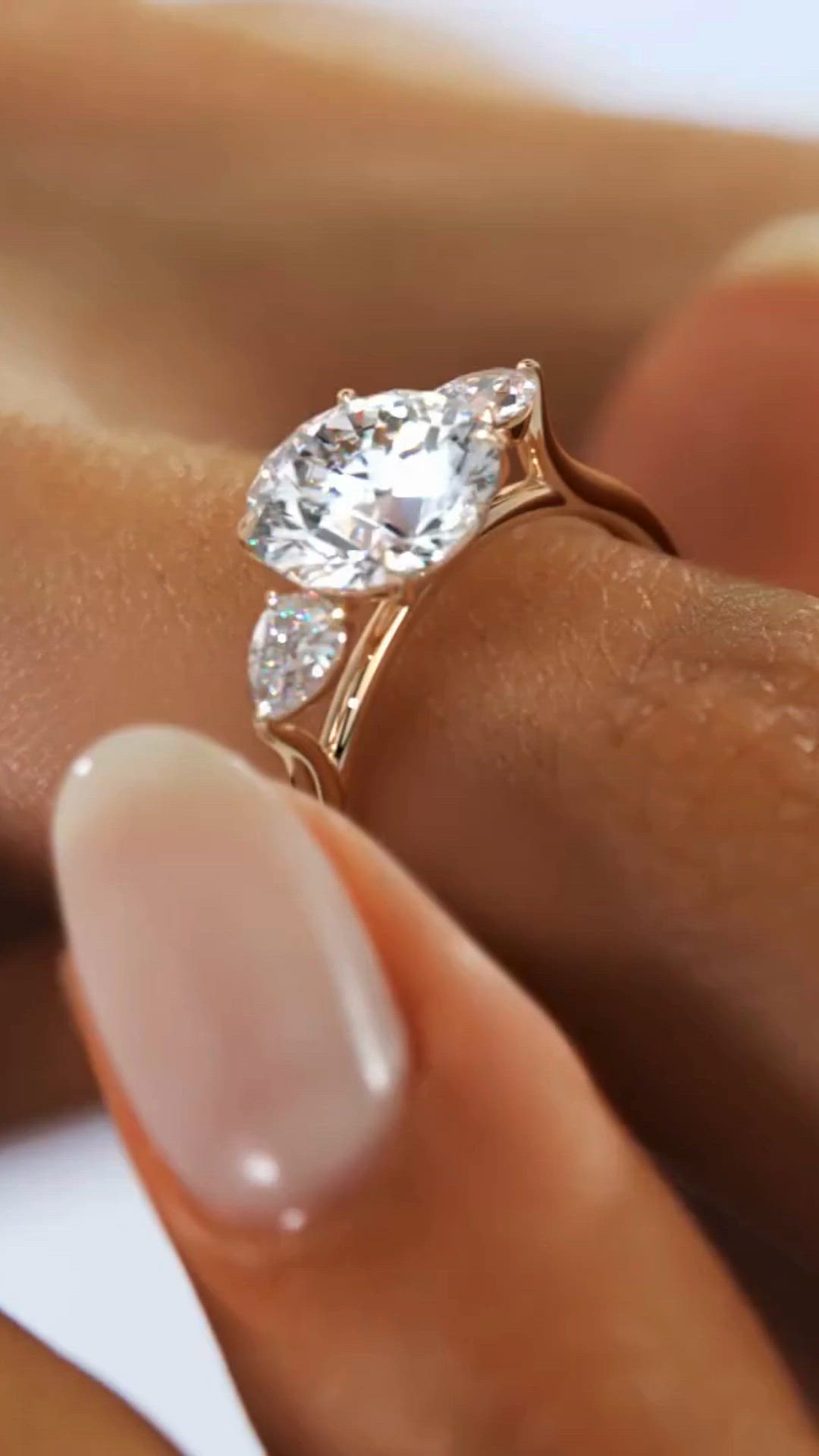 This may contain: a woman's hand holding a diamond ring