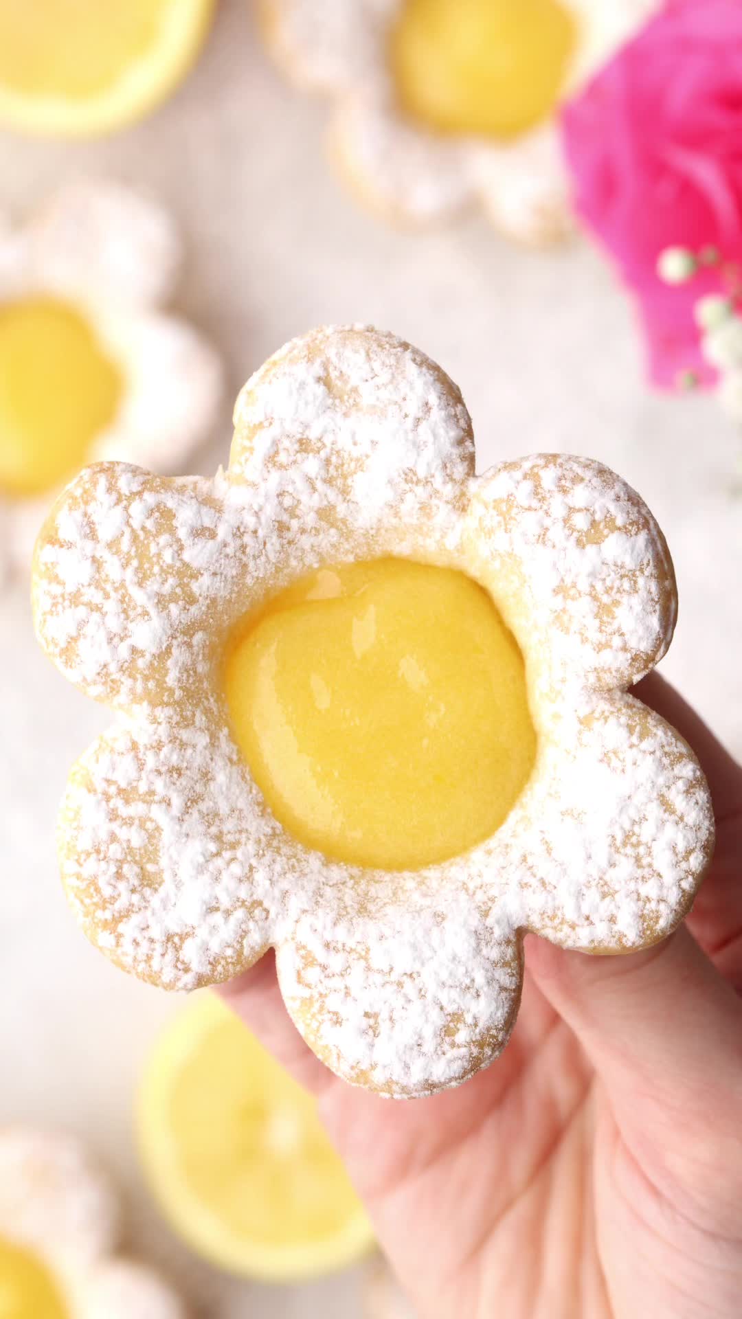 This may contain: lemon cookies with powdered sugar are arranged on a white surface, surrounded by lemon slices