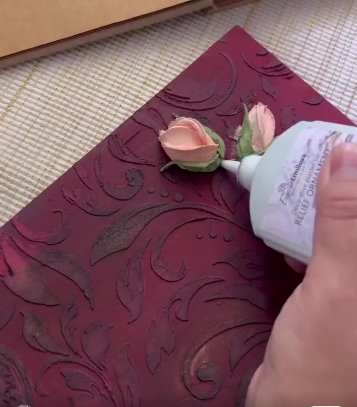 This may contain: some flowers are laying on top of a red piece of paper that is cut in half