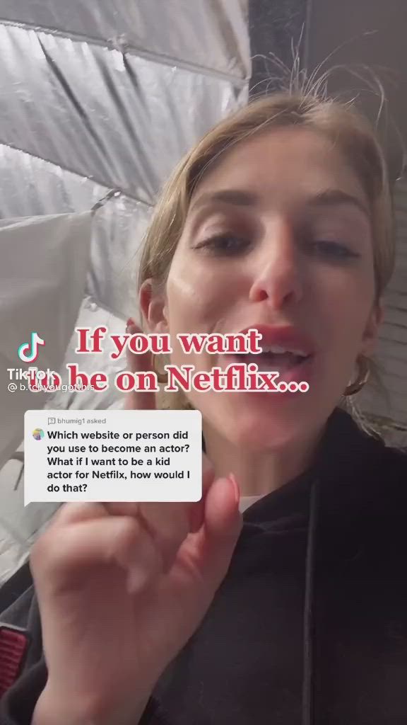 This may contain: a woman with her tongue out and an ad in the background that reads if you want to be on netflix