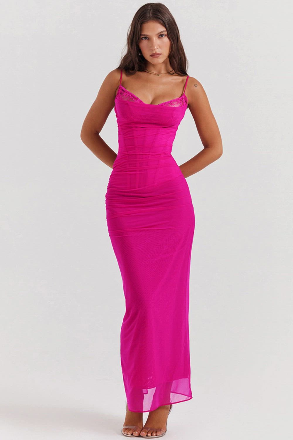 This contains: Discover the perfect balance of seduction and sophistication with our Lace Mesh Sexy Spaghetti Strap Maxi Dress. Crafted for the modern woman, this dress features a sleeveless design, backless cut, and bodycon fit for a figure-flattering silhouette. Perfect for any spring or summer party, this dress will have you feeling confident and irresistible.