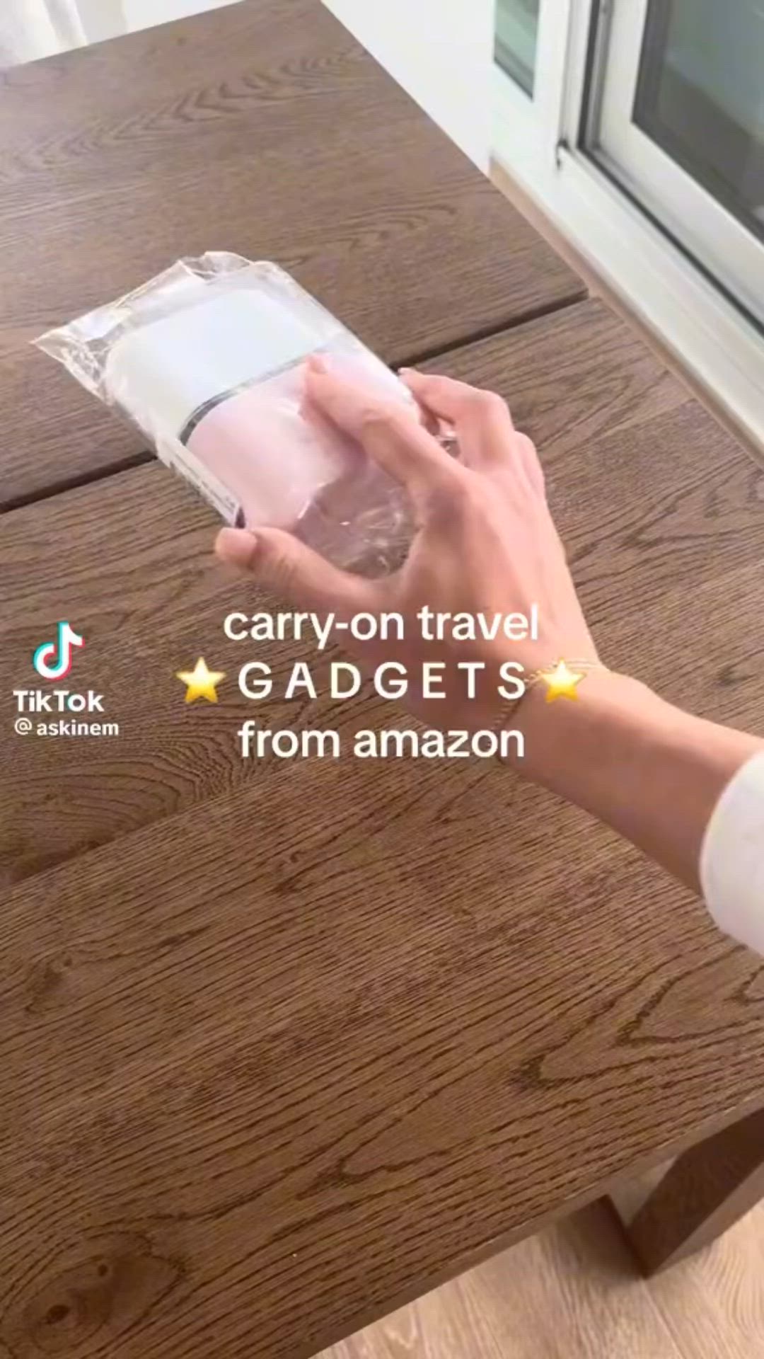 This may contain: a person is holding an item in their hand while sitting at a table with the words gadgets from amazon on it