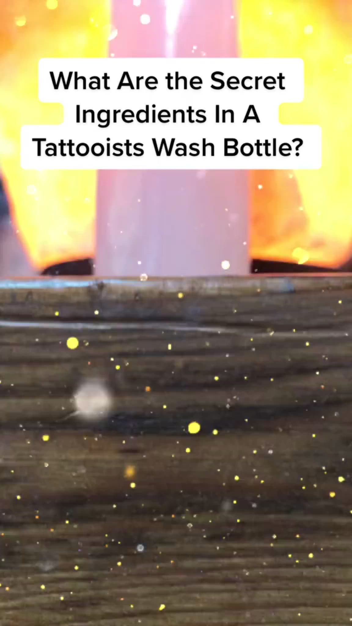 This may contain: a bottle sitting on top of a wooden table next to a light bulb with the words what are the secret ingredients in a tattooist's wash bottle?