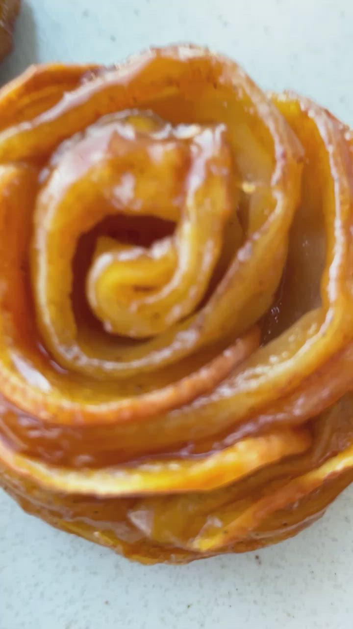 This may contain: there are many pieces of pastry on the table together, and one has been cut in half to look like a spiral