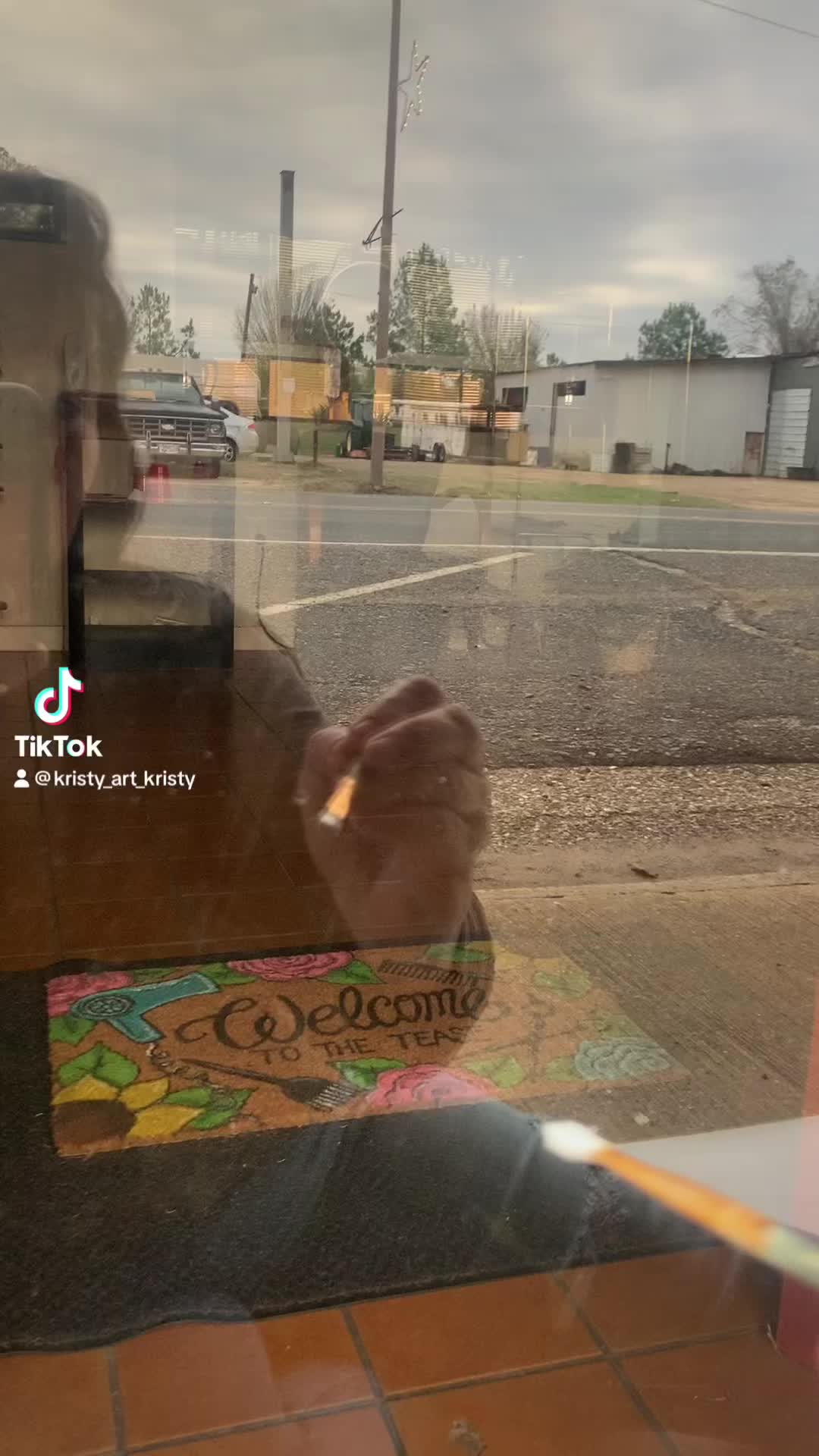 This may contain: a decorated christmas tree on the side of a store front window with candy canes and candies