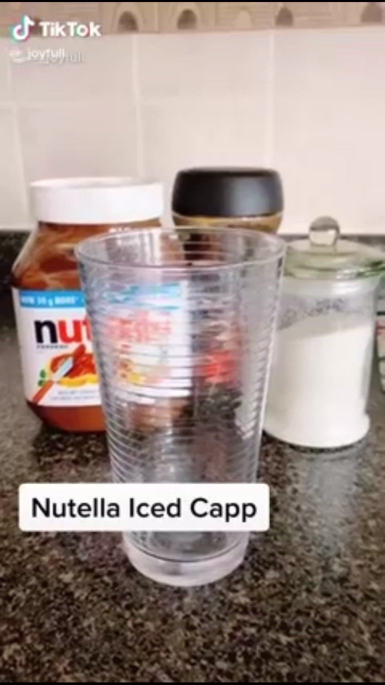 This may contain: nutella iced capp is sitting on the counter top next to jars and containers