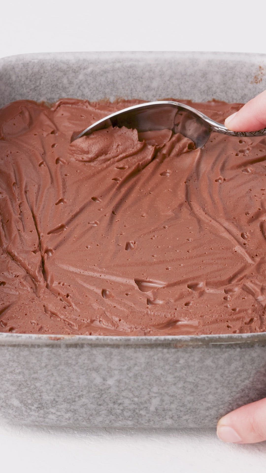 This may contain: a person spooning chocolate into a pan with the words how to make chocolate cremeux