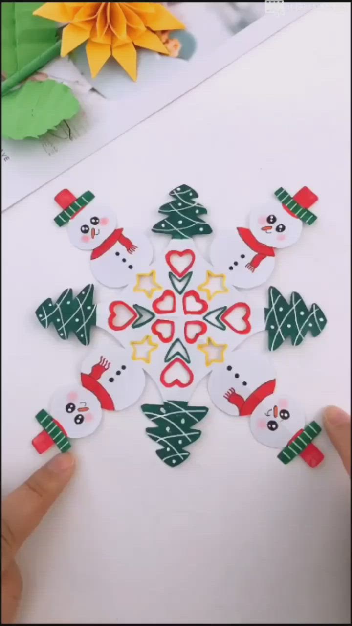 This may contain: someone is making a snowman ornament out of paper and some other decorations