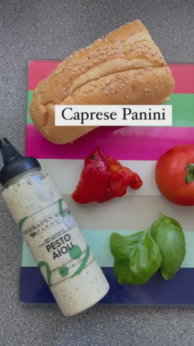 This may contain: an assortment of food sitting on top of a cutting board with the words caprese panini above it