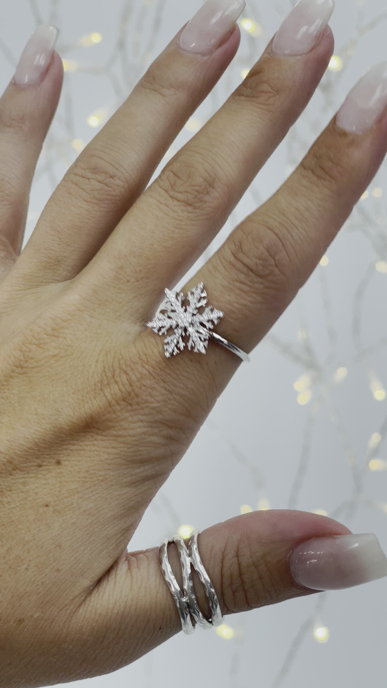 This contains: snowflake ring winter jewelry pointer finger ring