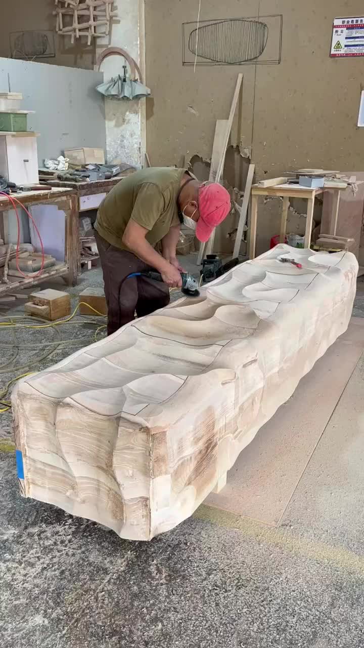 This may contain: a man working on a large piece of wood