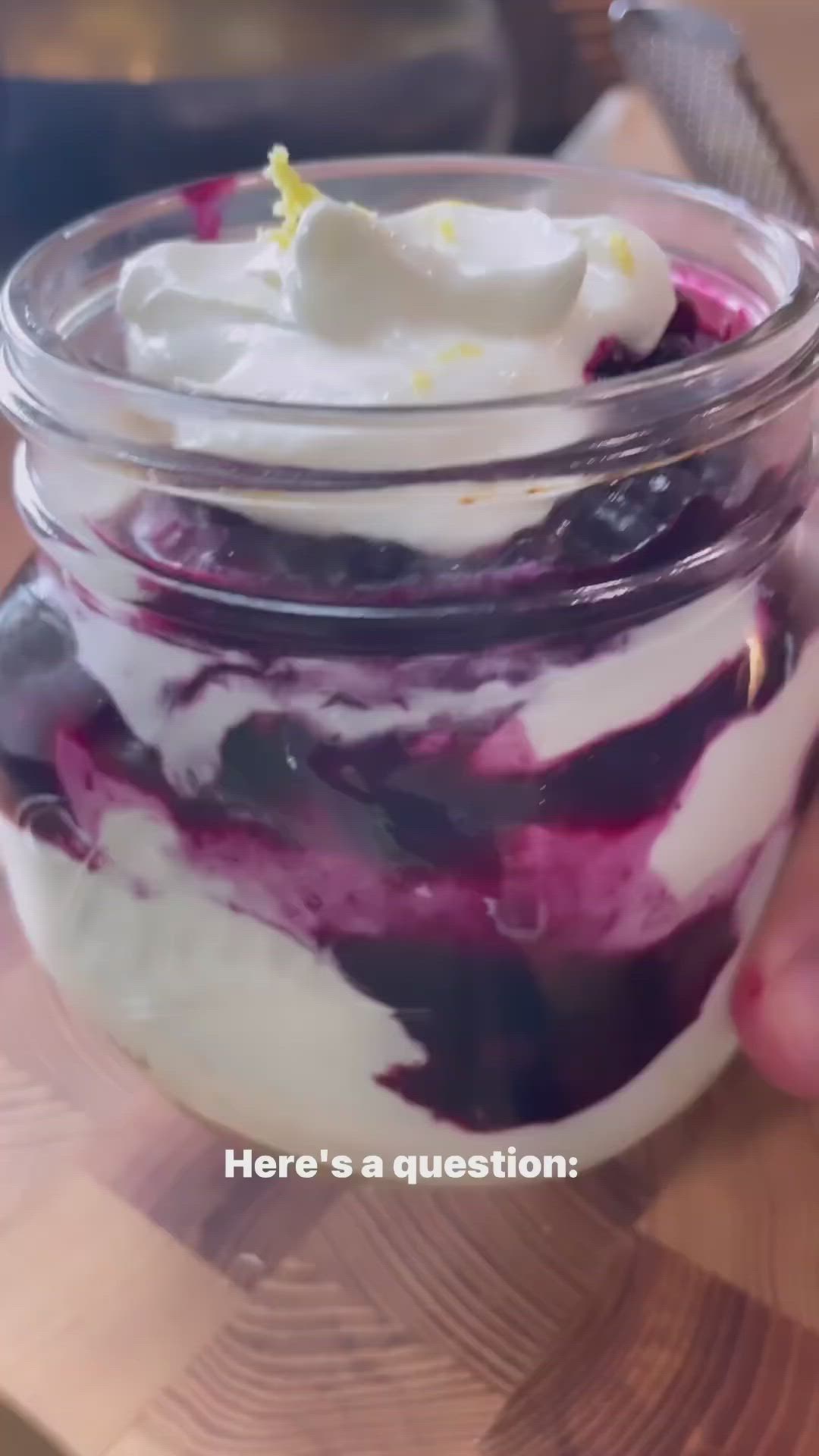 This may contain: cottage cheese blueberry parfait in a glass jar