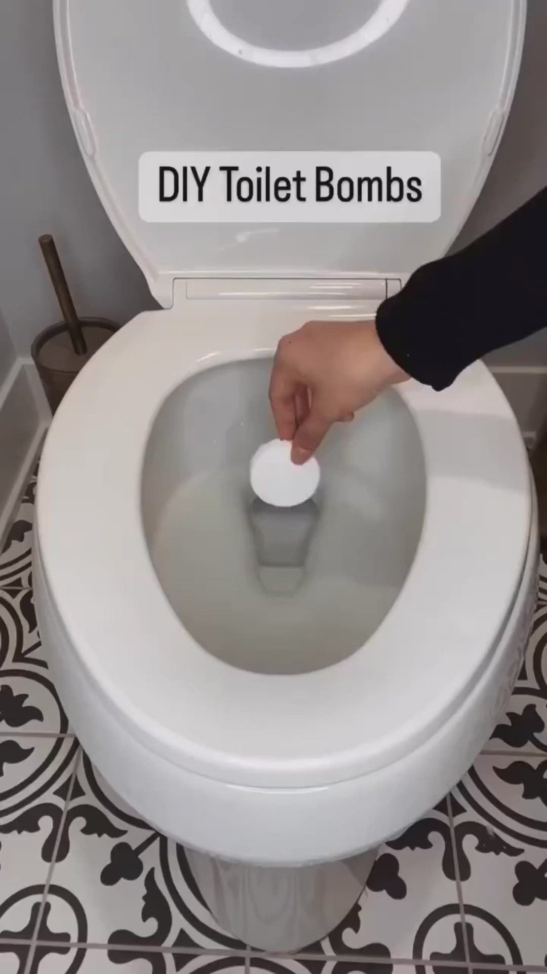 This may contain: a person is using a toilet bowl to flush the lid