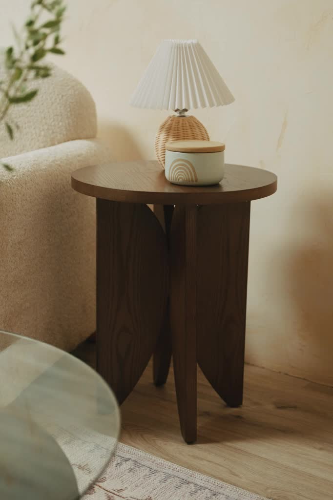 A distinctive curved leg design adds a modern update to a classic brown wooden side table. The natural grain add warmth to any room. Style with a plant for an extra dose of natural beauty. For a coordinated look, pair with the Kendall Coffee Table. Rounded table top Curved leg design Variance in wood grain Pair with the Kendall Coffee Table for a cohesive look Assembly required, hardware included