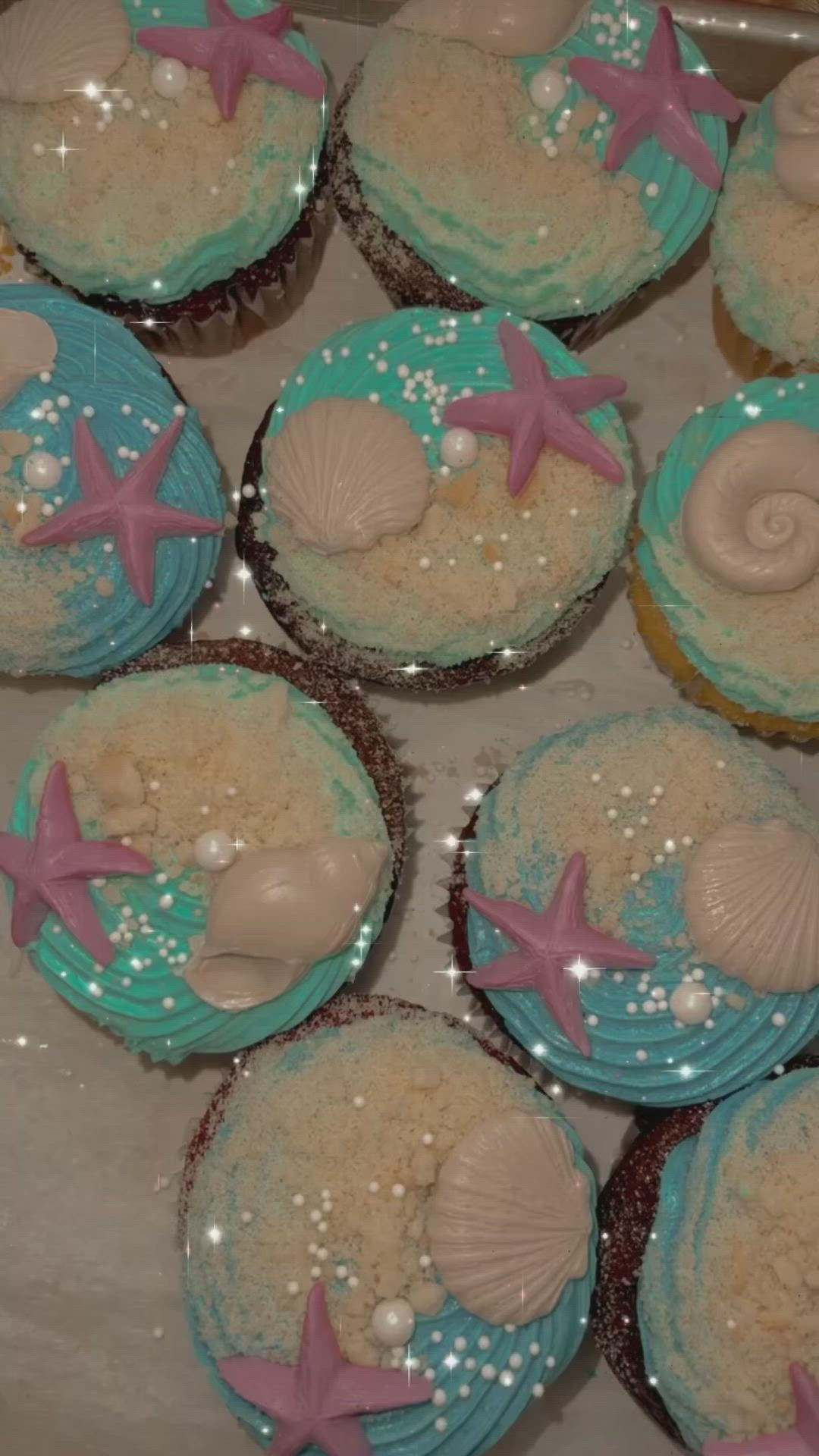 This may contain: cupcakes with sea shells and starfish on them