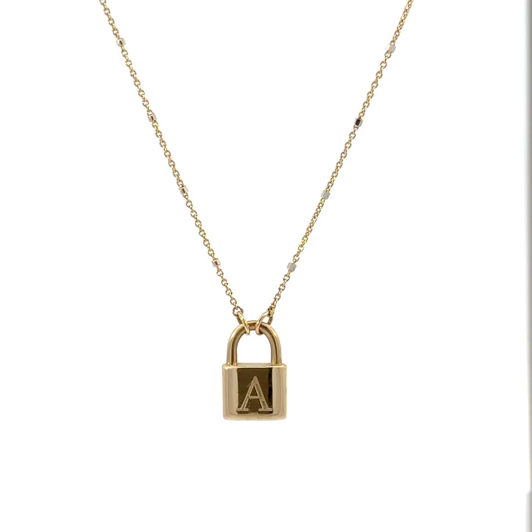 Lock in major style with this customizable Initial Padlock Sparkle Necklace. This beautiful piece is a reminder of love promised and the initials of people engraved will be forever locked and carried close to your heart. 

Size: 14.5mm(W) x 9.2mm(H)
Solid 14K Gold
Lifetime Guarantee
Made in Los Angeles