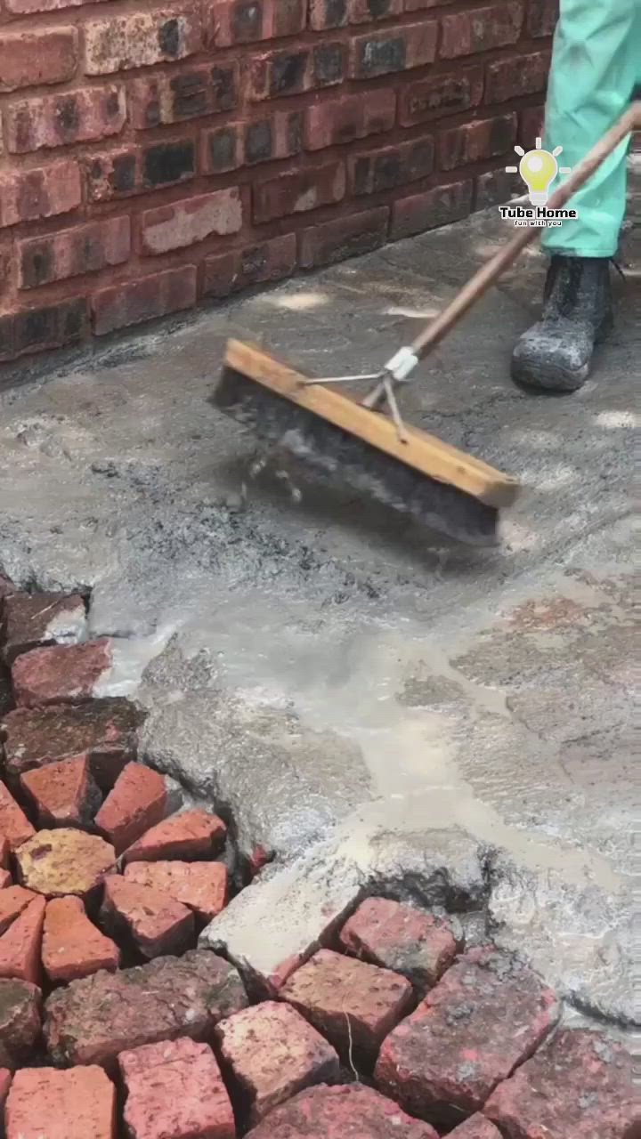 This may contain: a man is shoveling bricks into the ground