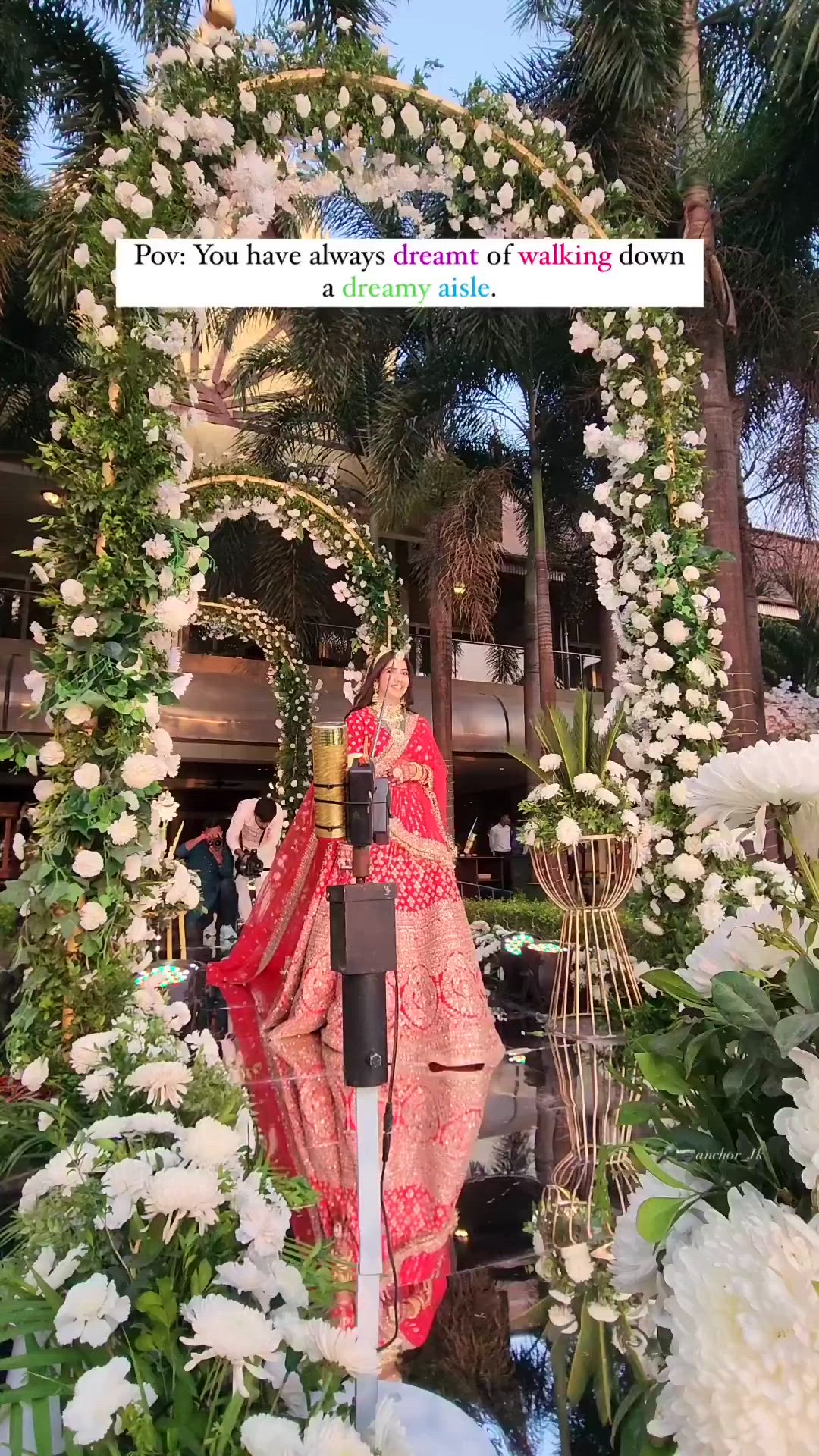 This may contain: a display with white flowers and greenery in front of a building that says, for you have always dream of walking down the aisle