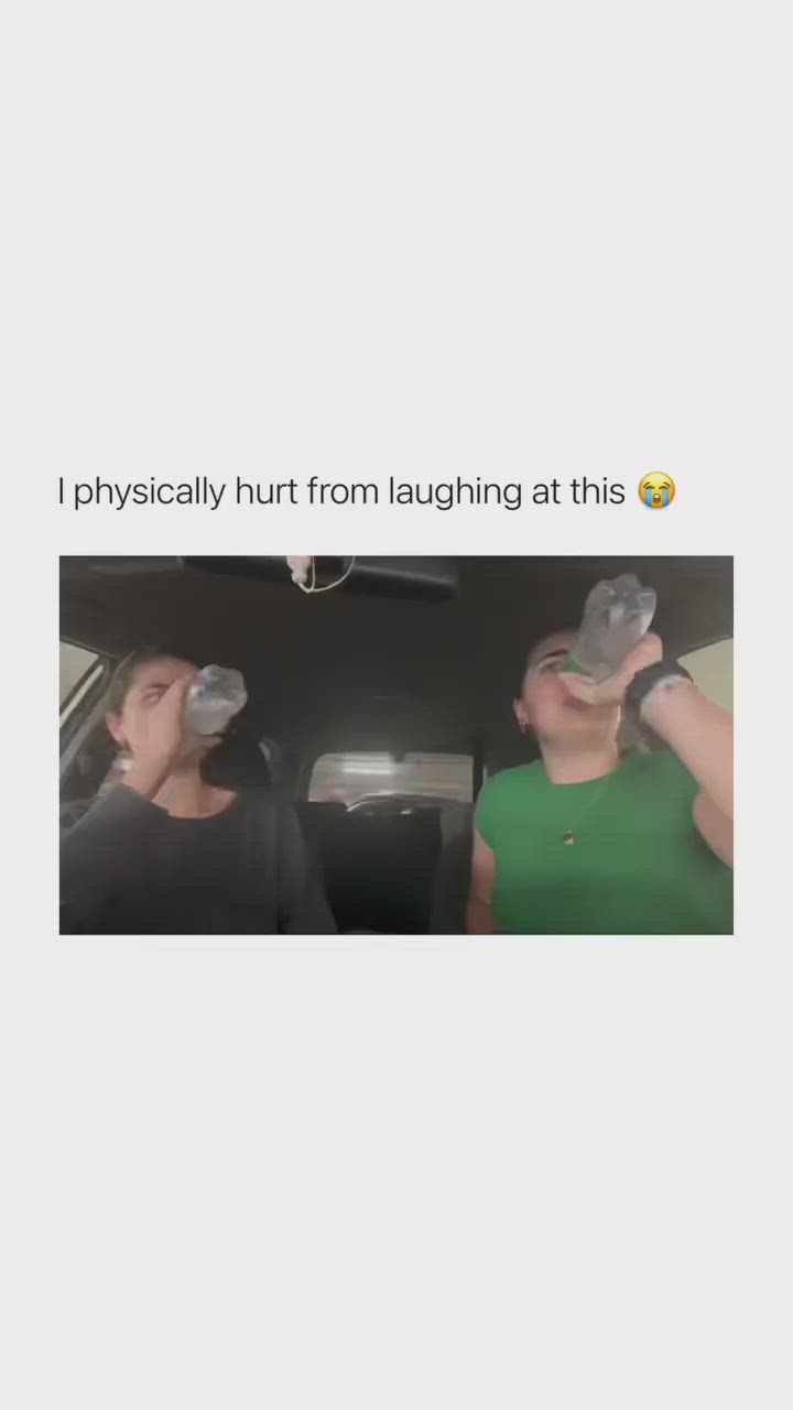 This may contain: two people in the back seat of a car with one person drinking from a water bottle