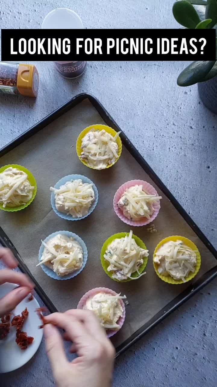 This may contain: someone is decorating cupcakes with white icing on a baking sheet and the words, looking for picnic ideas?