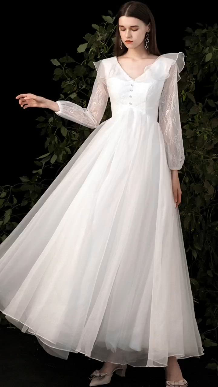 This contains: Fairytale Empire Wedding Dress Vneck with Ruffled Lace Long Sleeves