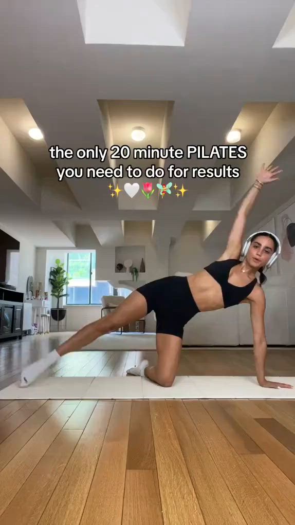 This may contain: a woman in a black swimsuit is doing yoga on a white mat with the words, the only 20 minute pilates you need to do for results