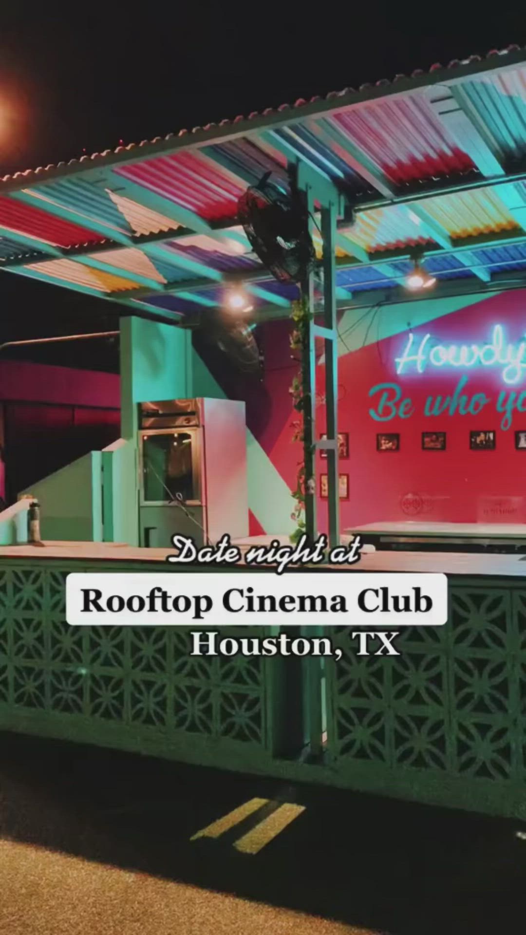 This may contain: the roof top cinema club houston, tx is lit up at night with colorful lights