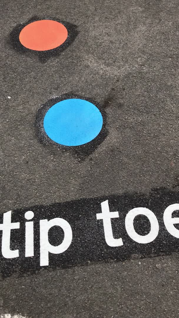 This may contain: a sign that says tip toe on the ground next to two circles with one blue dot