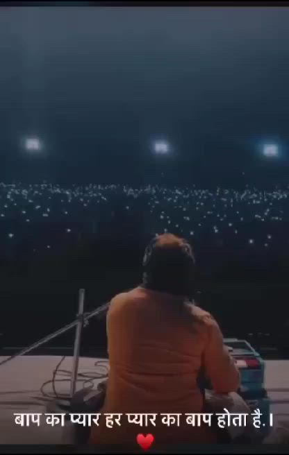 This may contain: a man sitting on top of a roof in front of a sky filled with lights